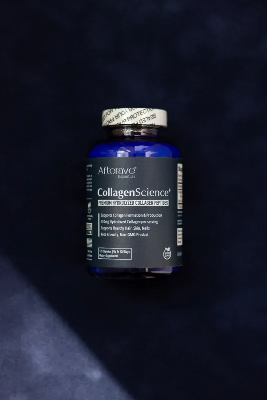 Supplement bottle photographed on dark navy fabric with a patch of light