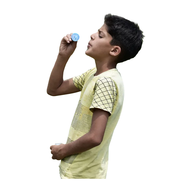 Boy blowing bubbles in a green field