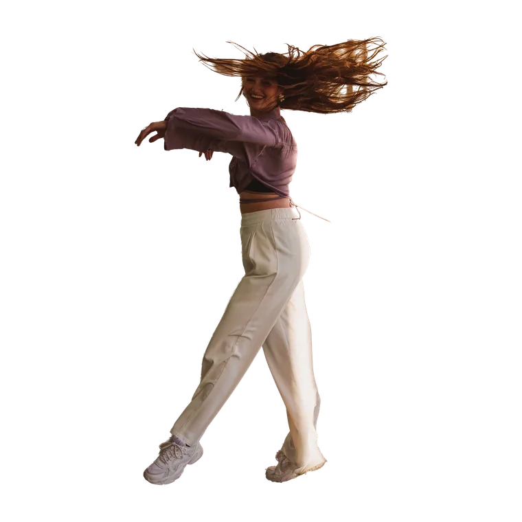 Dancer spinning in a sunlit corridor, hair caught mid-motion